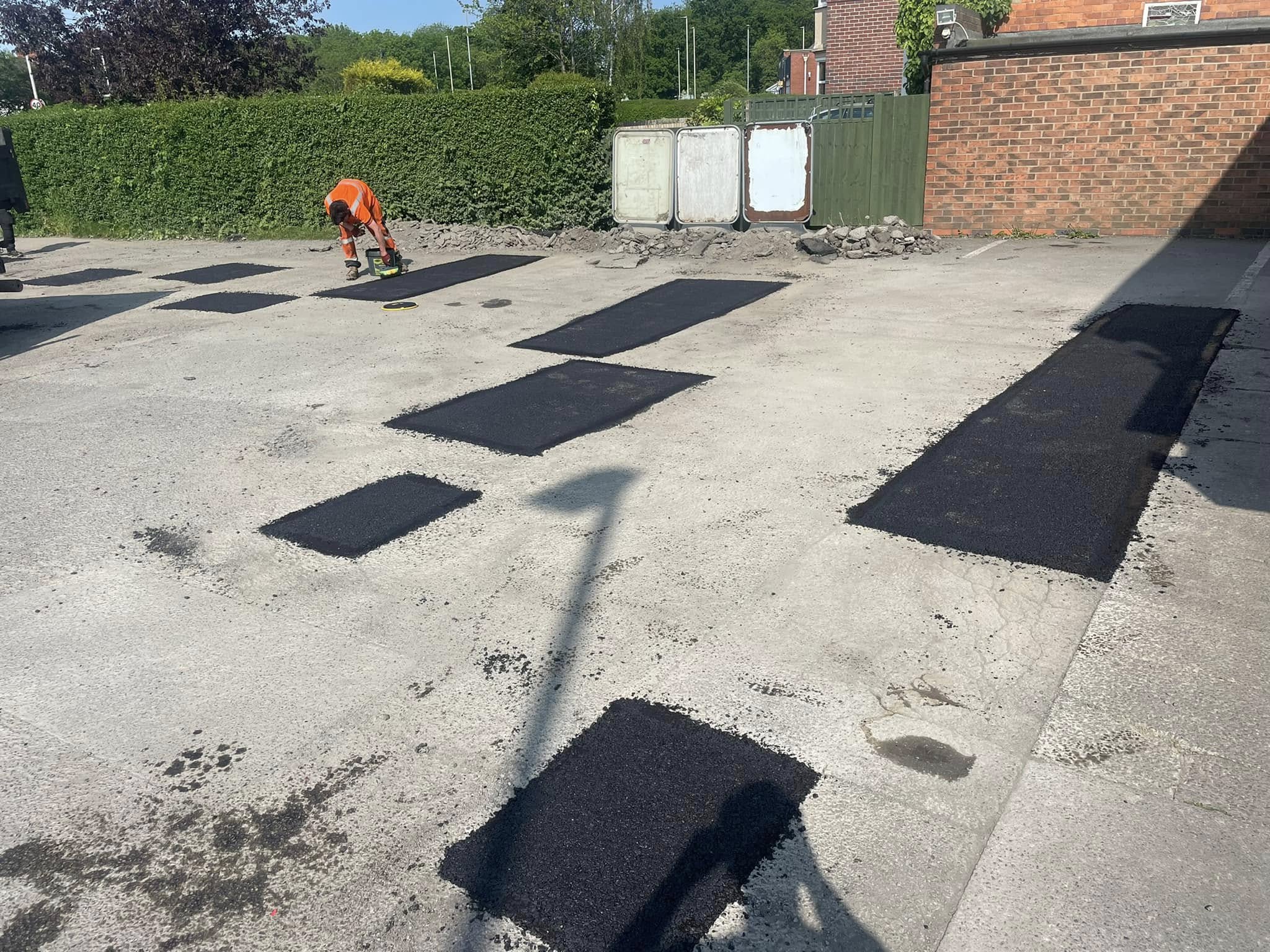 Pothole repair work in progress at a car park