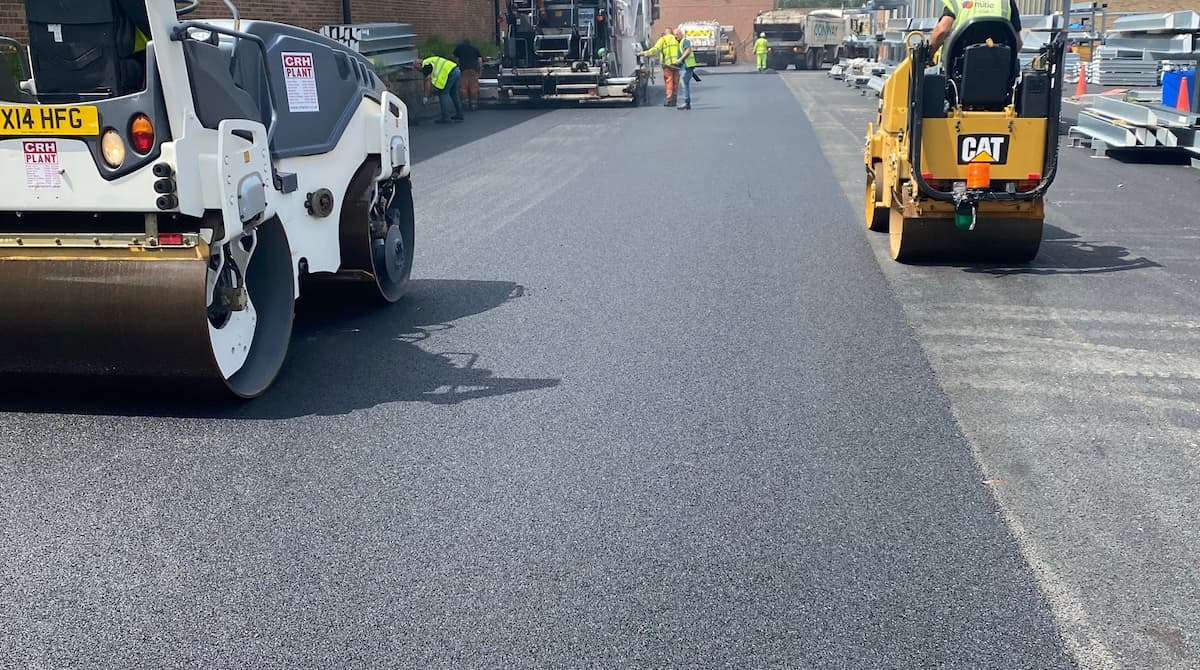 Tarmac road surfacing in progress with rollers